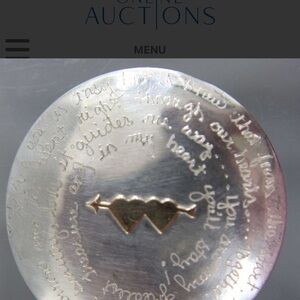 This is a Margie Lombard A Story Pin in sterling silver and 14 KT gold, engraved